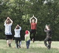 Yoga mit Kindern auf Wiese